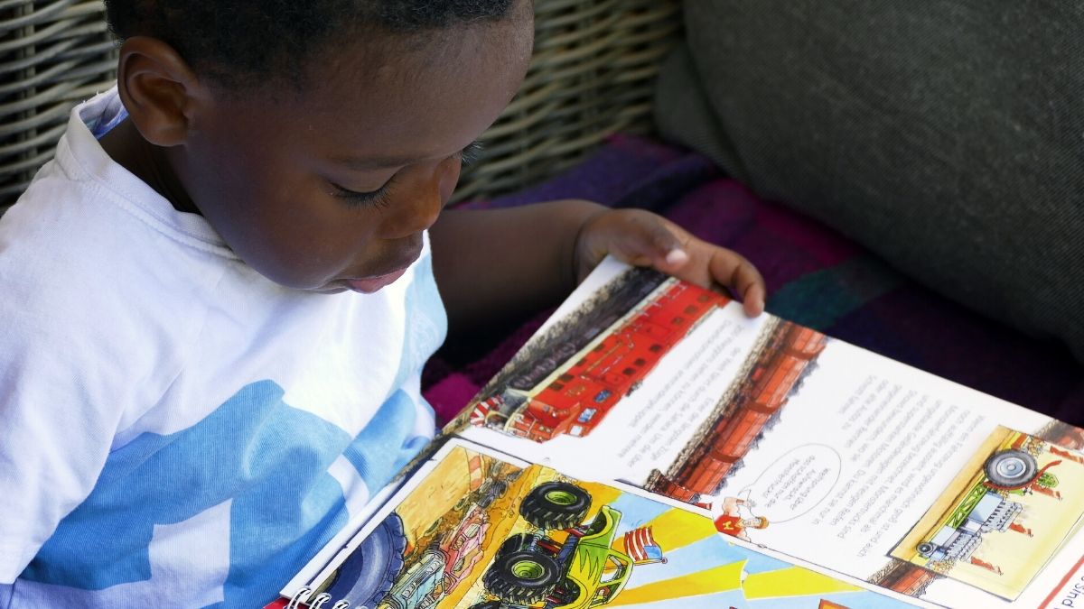 image of toddler boy reading a book